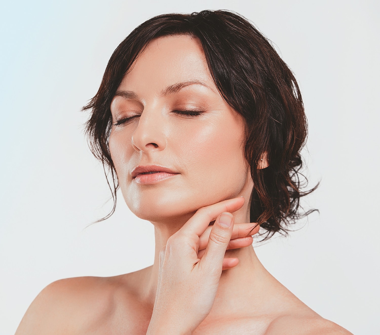 Portrait of a woman with long wavy hair.
