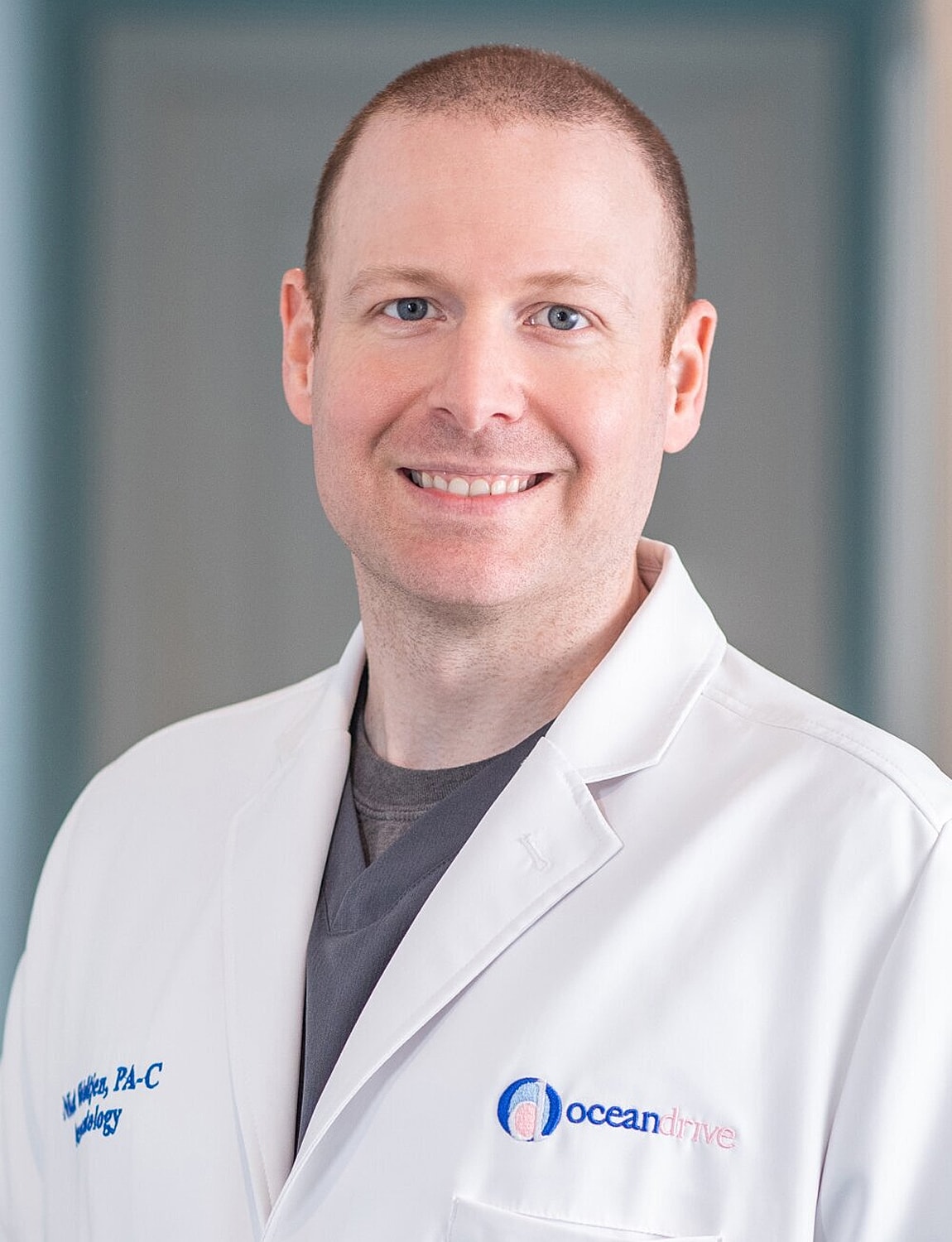 Woman with wavy hair and statement earrings.