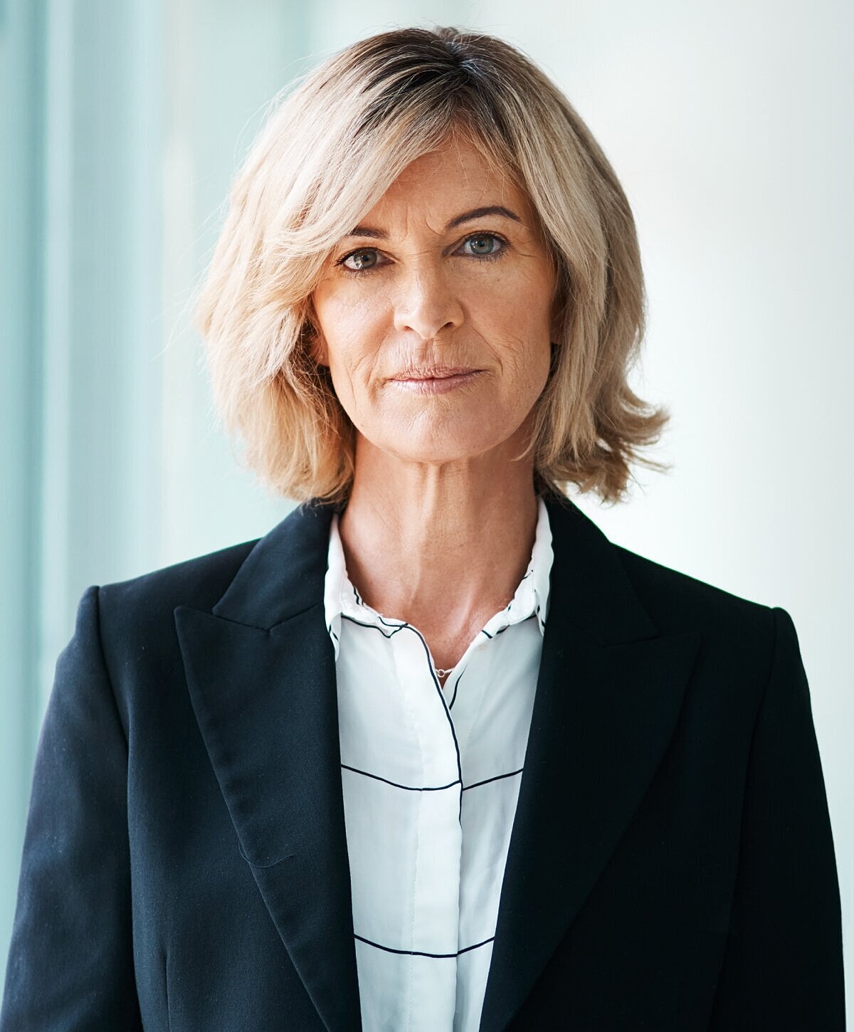 Portrait of a woman with long wavy hair.