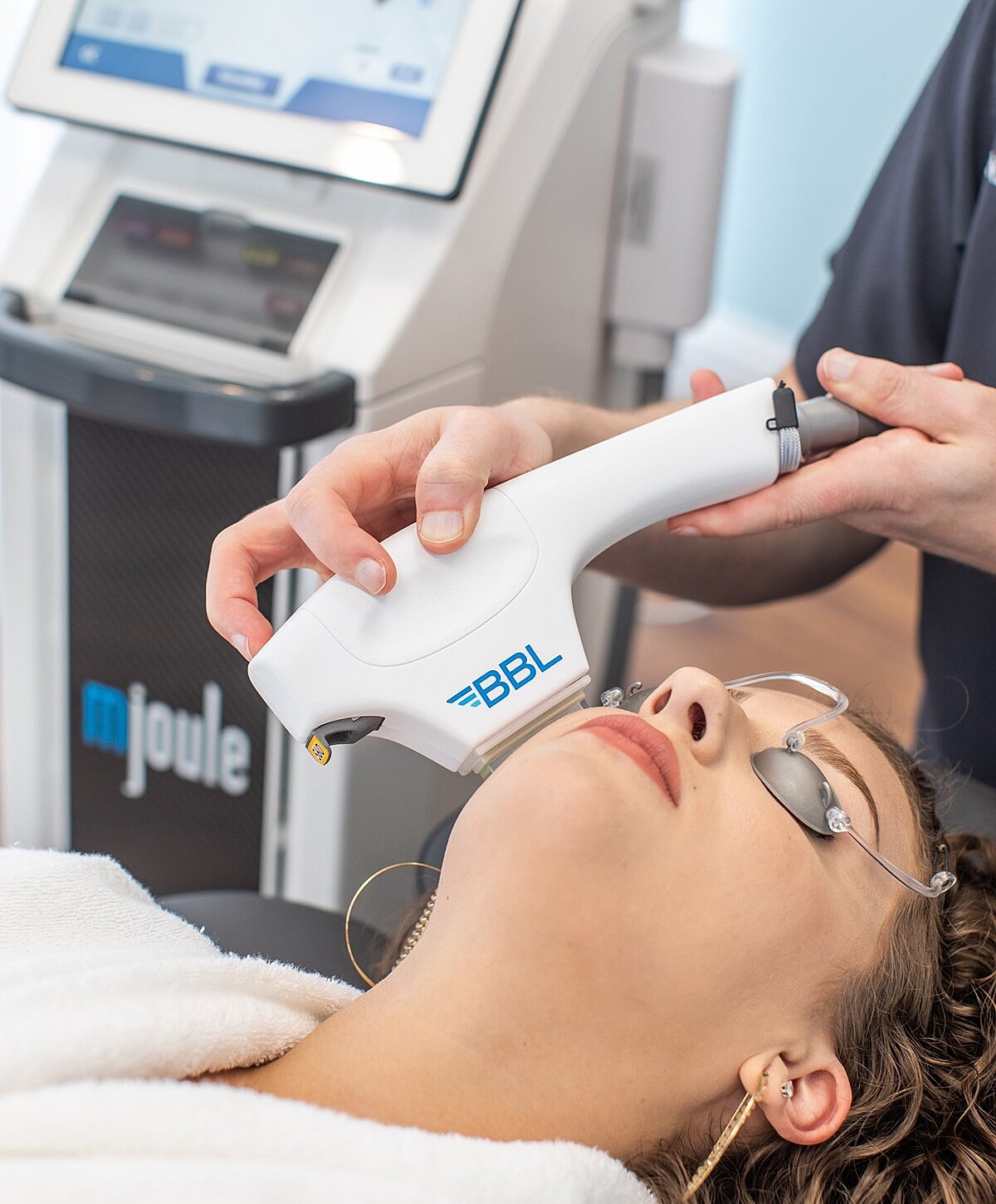 Portrait of a woman with long wavy hair.