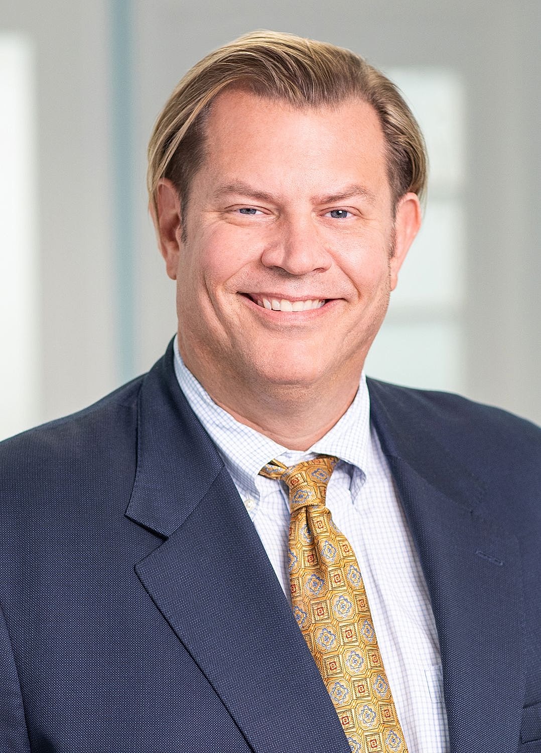 Portrait of a woman with long wavy hair.