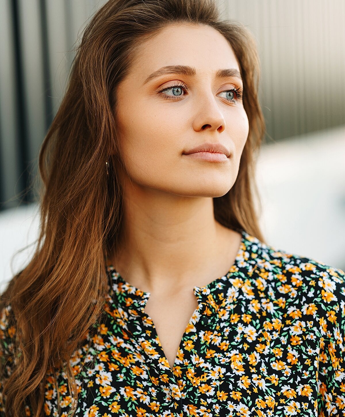 Portrait of a woman with long wavy hair.