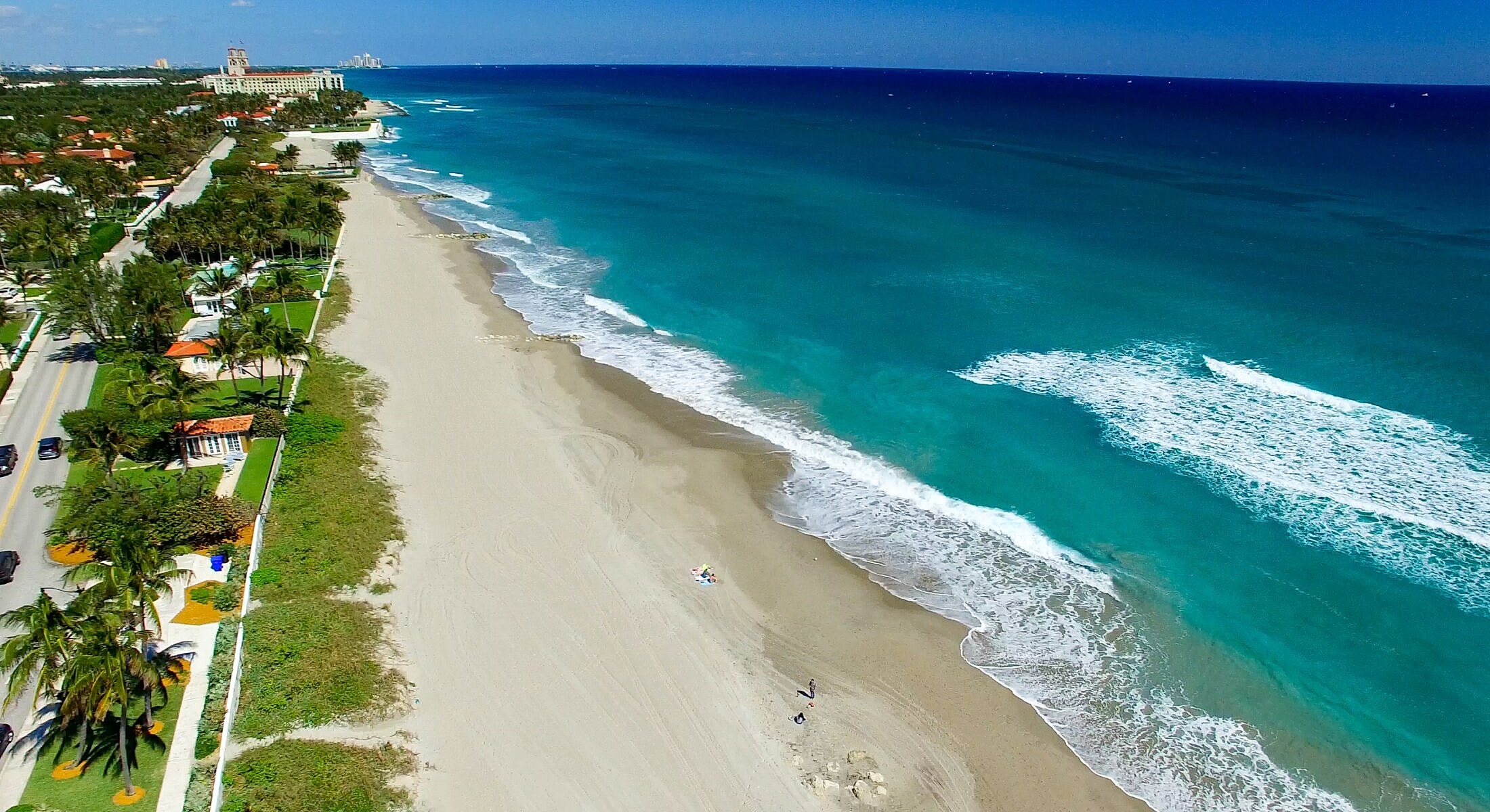 Aerial view of coastal city and turquoise waters.
